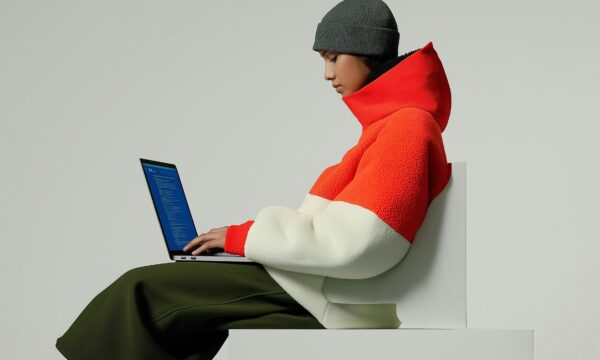Person in Color-Blocked Jacket with Laptop